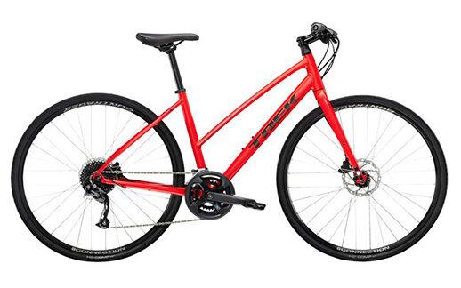 Bright red Trek FX Hybrid bike, ideal for comfortable and versatile riding on the mixed terrain of Helia self-guided cycling tours in Slovenia.