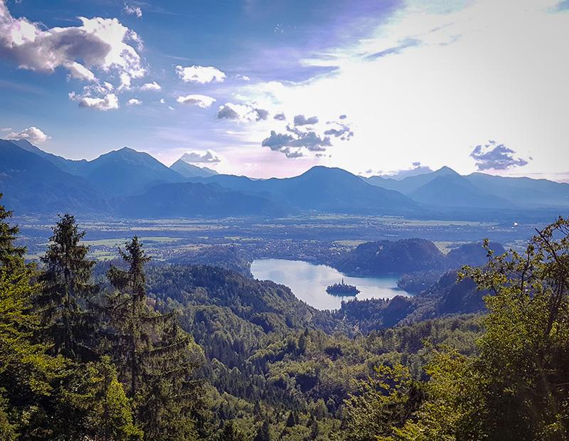 Classic panoramic view of the iconic Lake Bled, Slovenia, the island church, and the surrounding Julian Alps, showing the stunning landscape along Helia MTB cycling routes.