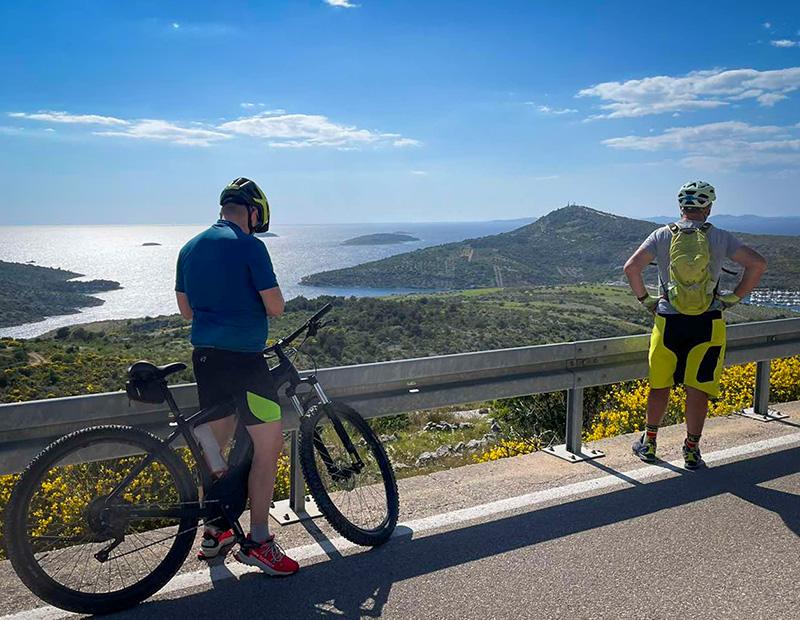 Two cyclists enjoying panoramic Adriatic Sea views Croatian islands bike tour