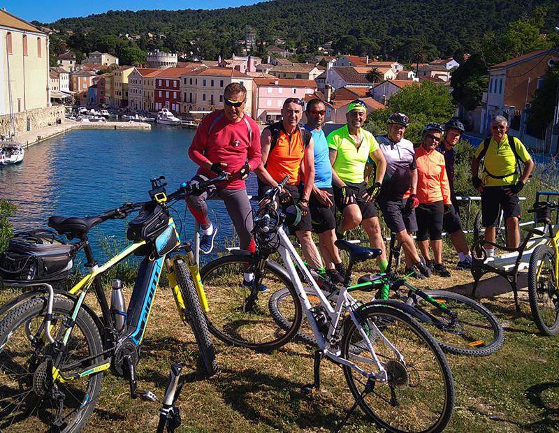 Cycling group at Croatian coastal harbor town Adriatic islands bike tour