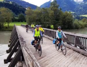 ciclovia alpe adria cyclist crossing wooden bridge